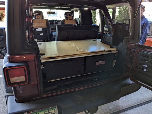 Sleeping Platform and drawer and fridge setup in a 4door Jeep JLU Wrangler. 