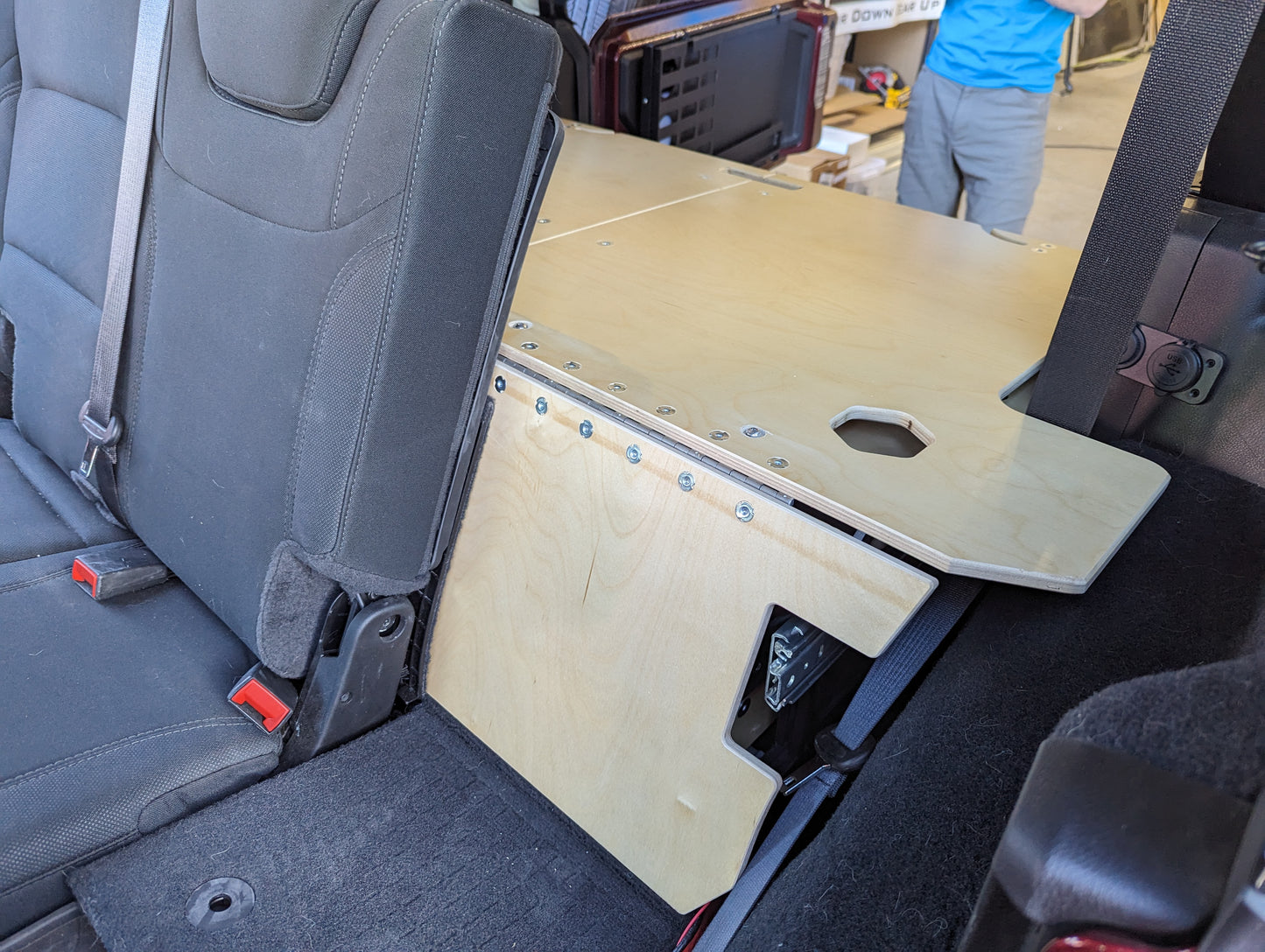 Convertible Sleeping Platform and drawer and fridge setup in a 4door Jeep JLU Wrangler. 